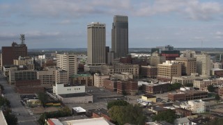 DX0002_170_021 - 5.7K aerial stock footage of skyscrapers towering over city buildings in Downtown Omaha, Nebraska