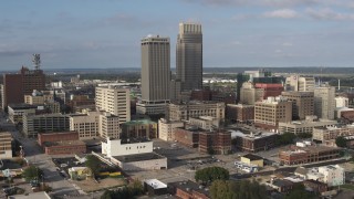 DX0002_170_026 - 5.7K aerial stock footage of circling skyscrapers towering over city buildings in Downtown Omaha, Nebraska