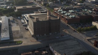 5.7K aerial stock footage ascend and orbit a brick office building at sunset, Downtown Omaha, Nebraska Aerial Stock Footage | DX0002_170_048