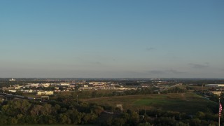 5.7K aerial stock footage of a wide, reverse view of the city at sunset, Council Bluffs, Iowa Aerial Stock Footage | DX0002_172_002