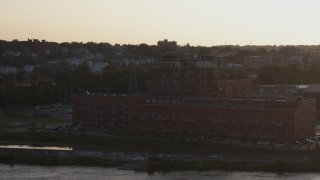 5.7K aerial stock footage orbit a riverfront apartment complex at sunset, Downtown Omaha, Nebraska Aerial Stock Footage | DX0002_172_017