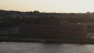 5.7K aerial stock footage of circling and flying away from a riverfront apartment complex at sunset, Downtown Omaha, Nebraska Aerial Stock Footage | DX0002_172_018