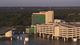 DX0002_172_020 - 5.7K aerial stock footage ascend and orbit the hotel and casino at sunset in Council Bluffs, Iowa