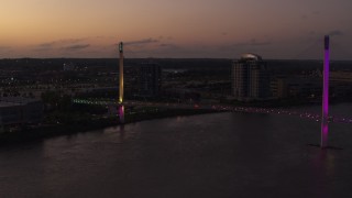 DX0002_172_048 - 5.7K aerial stock footage of flying by a pedestrian bridge spanning the Missouri River at twilight, Omaha, Nebraska