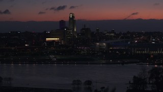 DX0002_173_005 - 5.7K aerial stock footage of passing by skyscrapers in the skyline at twilight, Downtown Omaha, Nebraska