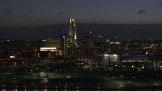 5.7K aerial stock footage of passing by the city's skyline at twilight, Downtown Omaha, Nebraska Aerial Stock Footage | DX0002_173_015