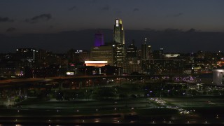 5.7K aerial stock footage of ascending past the city's skyline at twilight, Downtown Omaha, Nebraska Aerial Stock Footage | DX0002_173_016