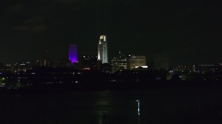 DX0002_173_038 - 5.7K aerial stock footage ascend toward tall skyscrapers at night, Downtown Omaha, Nebraska