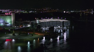 DX0002_173_047 - 5.7K aerial stock footage circling the parking garage at the hotel and casino at night in Council Bluffs, Iowa