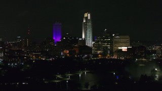 DX0002_173_058 - 5.7K aerial stock footage ascend and flyby towering skyscrapers and high-rises at night, Downtown Omaha, Nebraska