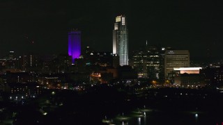 DX0002_173_060 - 5.7K aerial stock footage the city's skyscrapers seen from the park at night, Downtown Omaha, Nebraska