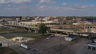 DX0002_174_008 - 5.7K aerial stock footage ascend by bridge for view of warehouse and downtown, Sioux City, Iowa