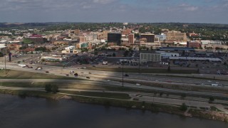 DX0002_174_014 - 5.7K aerial stock footage of office buildings and I-29 seen from the river, Downtown Sioux City, Iowa