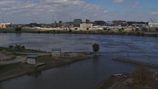 DX0002_174_021 - 5.7K aerial stock footage fly low over river, ascend for view of Downtown Sioux City, Iowa