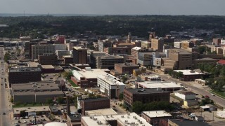 DX0002_175_025 - 5.7K aerial stock footage flying by the convention center and office buildings, Downtown Sioux City, Iowa