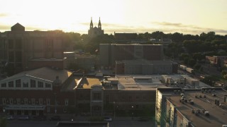 DX0002_176_027 - 5.7K aerial stock footage orbit county buildings, cathedral in background at sunset in Downtown Sioux Falls, South Dakota