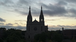 DX0002_176_036 - 5.7K aerial stock footage orbiting the Cathedral of Saint Joseph at twilight in Sioux Falls, South Dakota