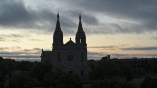 DX0002_176_038 - 5.7K aerial stock footage close orbit of the Cathedral of Saint Joseph at twilight in Sioux Falls, South Dakota