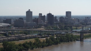 5.7K aerial stock footage of the skyline while flying by bridge spanning the river in Downtown Memphis, Tennessee Aerial Stock Footage | DX0002_177_012