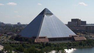 DX0002_177_022 - 5.7K aerial stock footage of descending by the waterfront Memphis Pyramid in Downtown Memphis, Tennessee