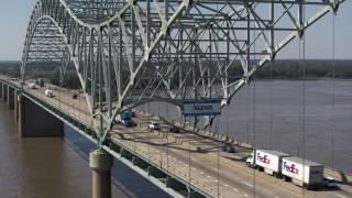 5.7K aerial stock footage of following cars crossing the bridge under a sign, Memphis, Tennessee Aerial Stock Footage | DX0002_177_029