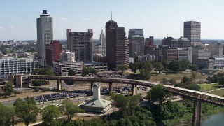 5.7K aerial stock footage of flying away from office towers in the Downtown Memphis, Tennessee skyline Aerial Stock Footage | DX0002_178_010