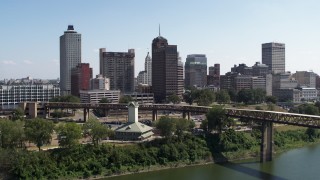 DX0002_178_011 - 5.7K aerial stock footage ascend over river toward office towers in the Downtown Memphis, Tennessee skyline