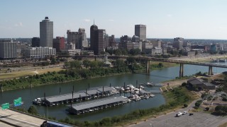 5.7K aerial stock footage flying past bridge traffic while focused on the skyline of Downtown Memphis, Tennessee Aerial Stock Footage | DX0002_178_040