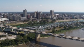 5.7K aerial stock footage fly away from river to reveal bridge while focused on the skyline of Downtown Memphis, Tennessee Aerial Stock Footage | DX0002_178_041