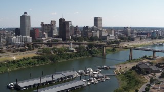 5.7K aerial stock footage descend with view of the skyline across the river, Downtown Memphis, Tennessee Aerial Stock Footage | DX0002_178_044