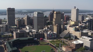 5.7K aerial stock footage of orbit two tall office towers and fly away for view of a baseball stadium in Downtown Memphis, Tennessee Aerial Stock Footage | DX0002_179_007