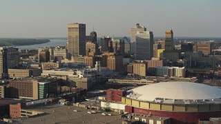 DX0002_180_032 - 5.7K aerial stock footage flying near FedEx Forum arena toward the skyline at sunset, Downtown Memphis, Tennessee