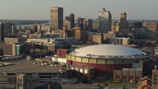 5.7K aerial stock footage descend toward FedEx Forum arena at sunset, skyline in background, Downtown Memphis, Tennessee Aerial Stock Footage | DX0002_180_037