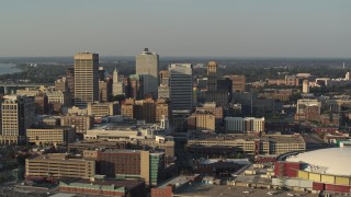 5.7K aerial stock footage slowly flyby office towers at sunset seen from the arena, Downtown Memphis, Tennessee Aerial Stock Footage | DX0002_180_041