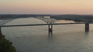 5.7K aerial stock footage of traffic crossing the Hernando de Soto Bridge at sunset, Downtown Memphis, Tennessee Aerial Stock Footage | DX0002_181_016