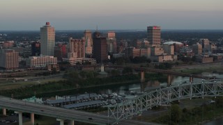 5.7K aerial stock footage of the city's skyline seen from the Hernando de Soto Bridge at sunset in Downtown Memphis, Tennessee Aerial Stock Footage | DX0002_181_023