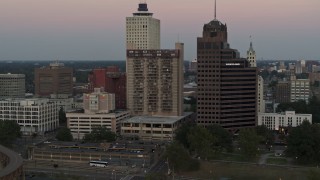 5.7K aerial stock footage flying by apartment and office high-rises at sunset in Downtown Memphis, Tennessee Aerial Stock Footage | DX0002_181_029