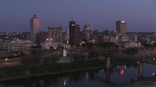 5.7K aerial stock footage a stationary view across Wolf River Harbor at the city's skyline at twilight in Downtown Memphis, Tennessee Aerial Stock Footage | DX0002_182_002