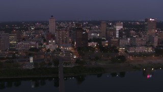 DX0002_182_006 - 5.7K aerial stock footage of a reverse view of downtown from across the river at twilight in Downtown Memphis, Tennessee