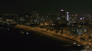 5.7K aerial stock footage a reverse view of downtown office buildings at night, Downtown Memphis, Tennessee Aerial Stock Footage | DX0002_182_017