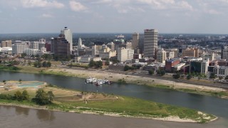 5.7K aerial stock footage flying away the city's skyline to the Mississippi River, Downtown Memphis, Tennessee Aerial Stock Footage | DX0002_183_013