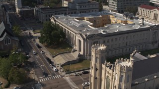 DX0002_184_027 - 5.7K aerial stock footage focus on courthouse and descend by church in Downtown Memphis, Tennessee