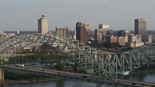 5.7K aerial stock footage of the skyline seen while flying by the top of the bridge at sunset, Downtown Memphis, Tennessee Aerial Stock Footage | DX0002_185_022