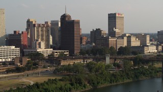 5.7K aerial stock footage of Raymond James Tower and city buildings at sunset, Downtown Memphis, Tennessee Aerial Stock Footage | DX0002_185_026