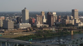 5.7K aerial stock footage of a reverse view of the skyline at sunset, and reveal the bridge, Downtown Memphis, Tennessee Aerial Stock Footage | DX0002_185_028