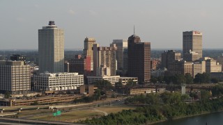 5.7K aerial stock footage of flying away from the downtown skyline at sunset, Downtown Memphis, Tennessee Aerial Stock Footage | DX0002_185_032