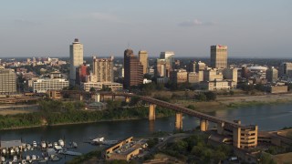 DX0002_186_005 - 5.7K aerial stock footage of a wide flight around the downtown skyline at sunset, Downtown Memphis, Tennessee