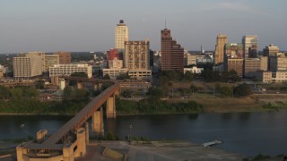 5.7K aerial stock footage of the welcome center, bridge, apartment complex and office tower at sunset, Downtown Memphis, Tennessee Aerial Stock Footage | DX0002_186_023