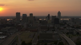 5.7K aerial stock footage of the setting sun above the city skyline, Downtown Memphis, Tennessee Aerial Stock Footage | DX0002_186_024