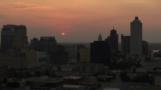 5.7K aerial stock footage orbit office towers with view of setting sun, Downtown Memphis, Tennessee Aerial Stock Footage | DX0002_186_032